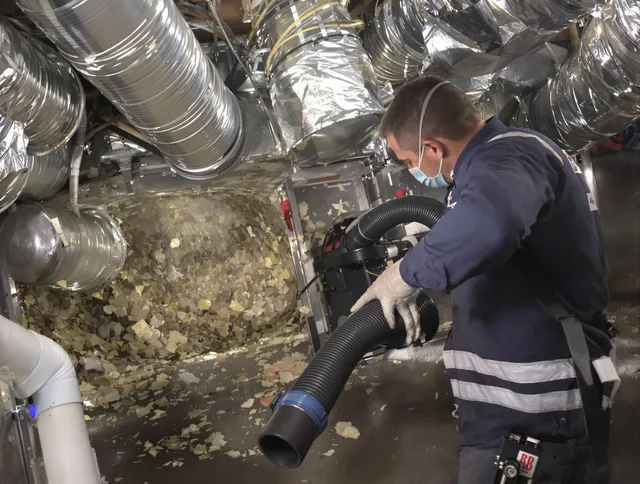 Carver Air Duct Cleaning specialist operating negative pressure cleaning equipment for thorough duct maintenance in Carver